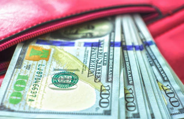 istock dollar notes in a wallet, hundred-dollar bills are in a bag, 1417897446