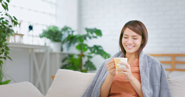 istock woman having hot drink 1417898464