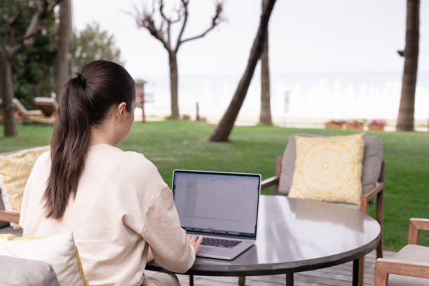 istock Young woman using laptop outdoor in summer. Distant work, working online concept 1417898492