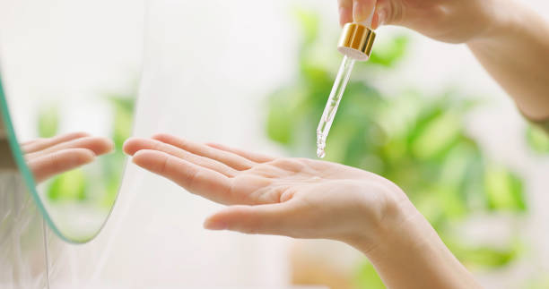 istock woman applying essential serum 1417898755