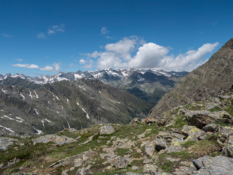 view of mountain and snow-capped peaks at Stubai hiking trail, Stubai Hohenweg, Summer rocky alpine landscape of Tyrol, Stubai Alps, Austria.