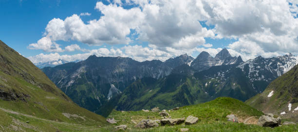 istock Panoramic view from Pramarnspitze saddle on snow-capped moutain panorama at Stubai hiking trail, Stubai Hohenweg, Alpine landscape of Tyrol Alps, Austria. Summer blue sky, white clouds 1417900461