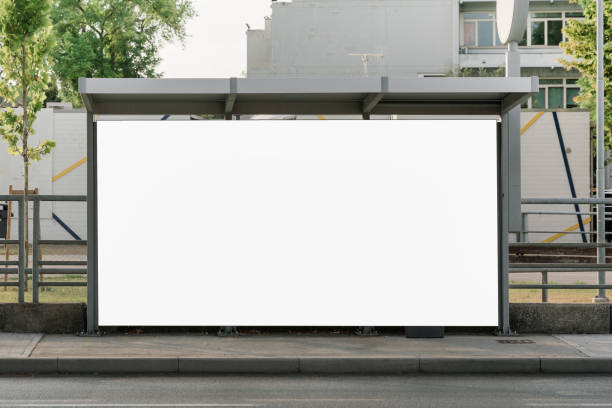 Large empty commercial banner mounted on urban bus stop Large empty commercial banner mounted on urban bus stop front view outdoor wind shelter stock pictures, royalty-free photos & images