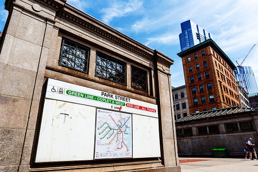 Boston, Massachusetts, USA - August 21, 2022: A Massachusetts Bay Transportation Authority's (MBTA) Park Street subway station on the corner of Park and Tremont Streets in downtown Boston. Large sign shows map of MBTA subway routes.