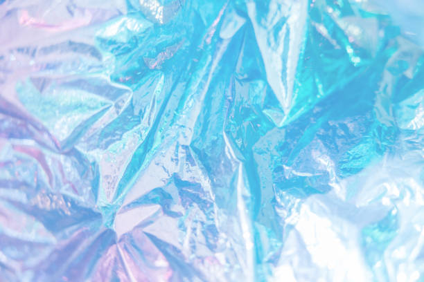 istock Iridescent foil texture background. Holographic wrinkled surface. Vibrant blue gradient template for design. Banner with copy space 1417902826