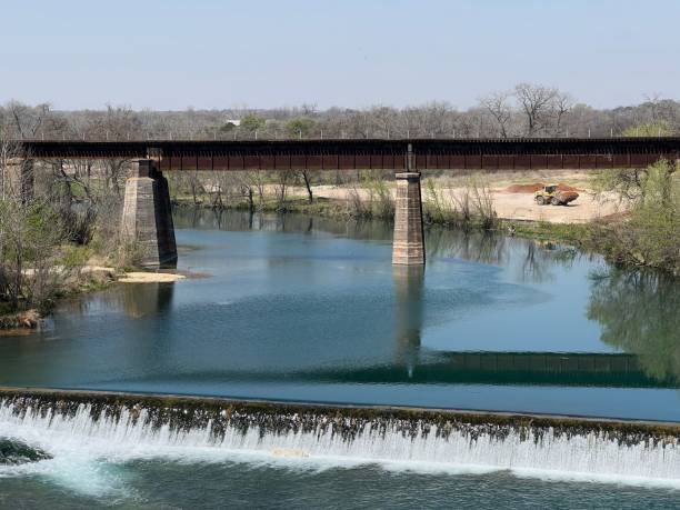 istock View of a bridge reflecting on a water dam on a sunny day 1417903861