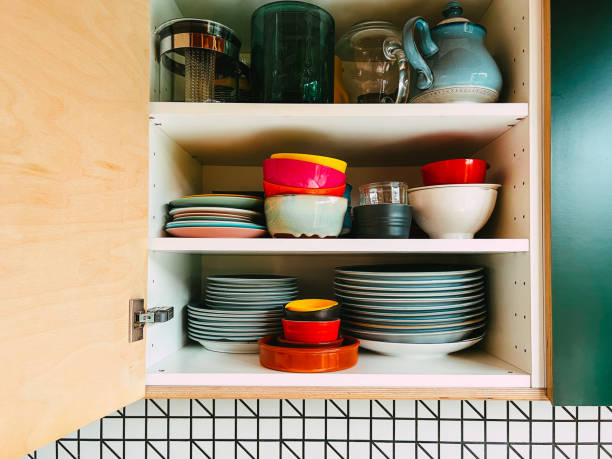 istock Colorful plates and bowls stacked in kitchen cupboard 1417905785