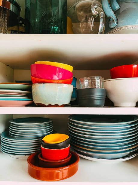 istock Colorful plates and bowls stacked in kitchen cupboard 1417905788