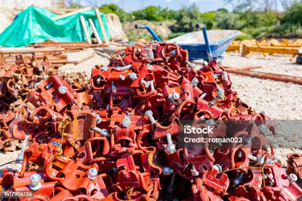 Pile Of Dismantled Scaffolding Joints Scattered On The Groundview On Heap Of Disassembled Steel Scaffolding Joint On Construction Site Stock Photo - Download Image Now