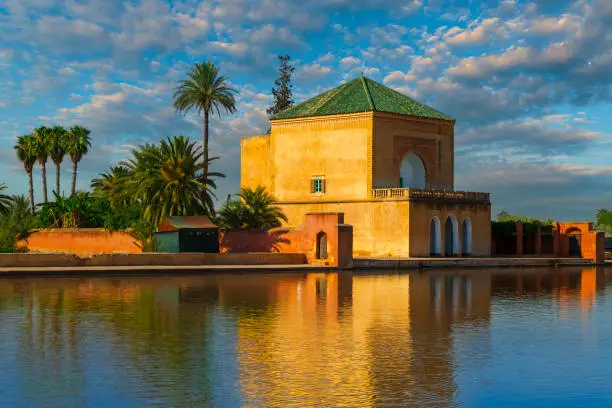 Famous pavilion by the pool in Jardin Menara, Marrakesh, (Morocco). It is one of the public parks preferred by Moroccan people to visit. It is located in the middle of the city of Marrakech.