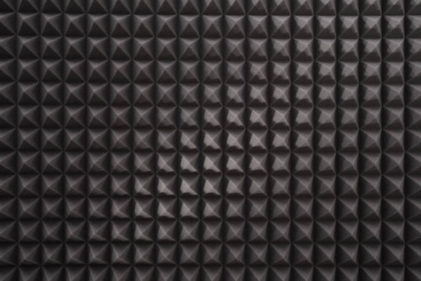 istock Dark gray triangular acoustic and studio sound proof foam pattern texture. Surface of noise acoustic foam 1417906565