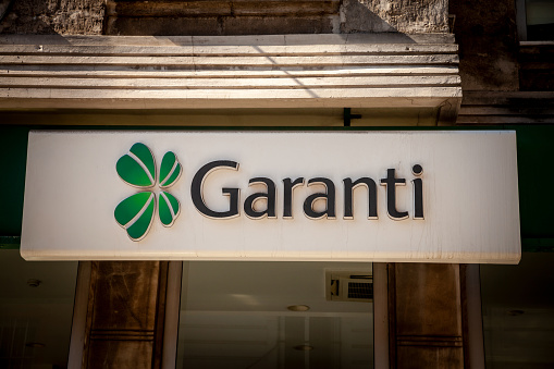 Picture of a sign with the logo of Garanti Bankasi taken in front of their local bank in Istanbul, Turkey. Garanti BBVA (legal name Türkiye Garanti Bankas A.; formerly referred to as Garanti Bank in English) is a Turkish financial services company based in Turkey. 86% of Garanti's stakes are owned by the Spanish bank Banco Bilbao Vizcaya Argentaria (BBVA).