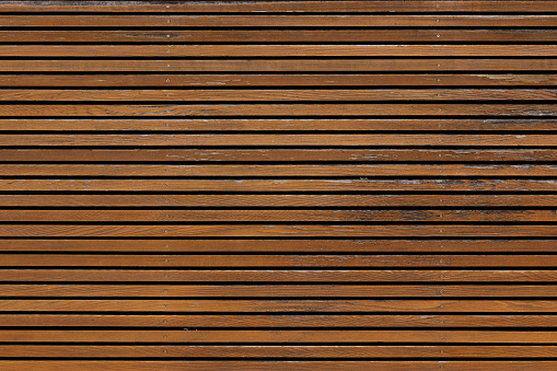 Section of an old brown wooden wall.