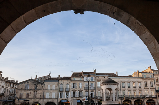 Picture of the cityscape of Libourne, France, with a focus on place Abel Surchamp square, a typical medieval square street, in the city center. Libourne is a commune in the Gironde department in Nouvelle-Aquitaine in southwestern France. It is a sub-prefecture of the department.