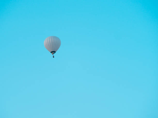 istock white hot air balloon on blue sky 1417910957