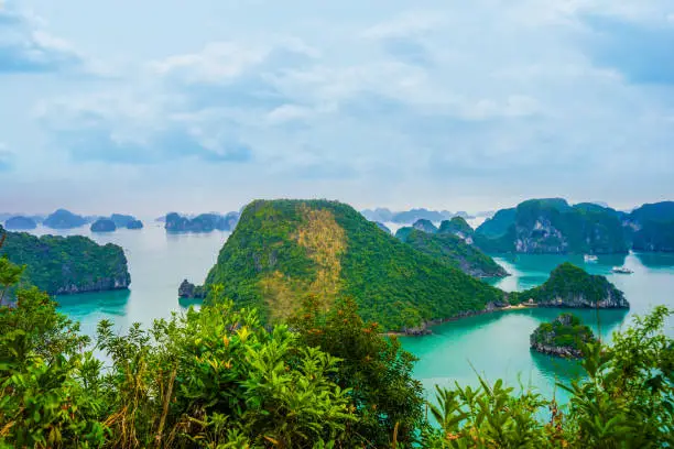 Aerial view of sunset and dawn near rock island, Halong Bay, Vietnam, Southeast Asia. UNESCO World Heritage Site. Junk boat cruise to Ha Long Bay. Popular landmark of Vietnam