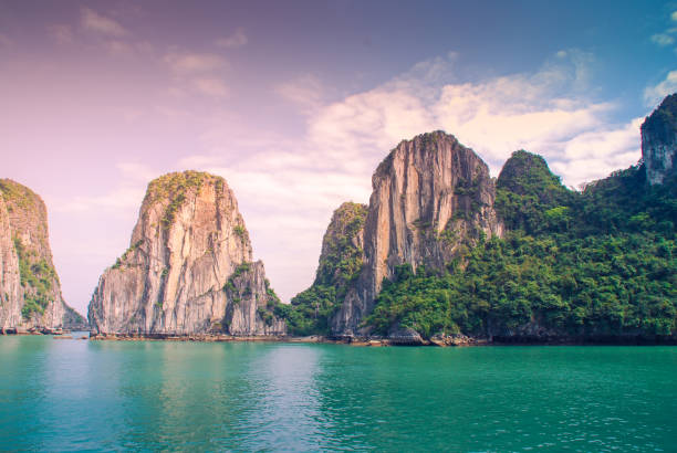 Aerial view of sunset and dawn near rock island, Halong Bay, Vietnam, Southeast Asia. UNESCO World Heritage Site. Junk boat cruise to Ha Long Bay. stock photo