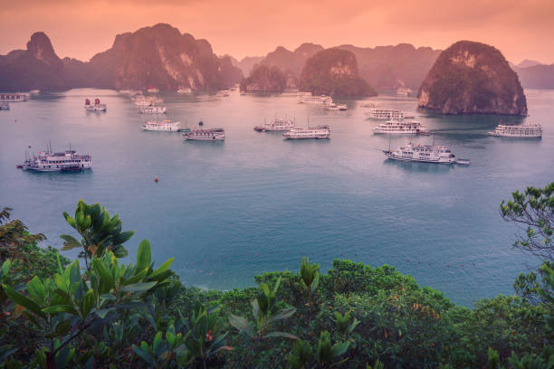 Aerial view of sunset and dawn near rock island, Halong Bay, Vietnam, Southeast Asia. UNESCO World Heritage Site. Junk boat cruise to Ha Long Bay. stock photo