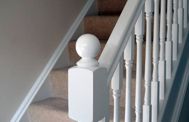 A freshly decorated wooden staircase in a modern home. A wooden staircase with carpet on the stairs in a contemporary home. baluster stock pictures, royalty-free photos & images