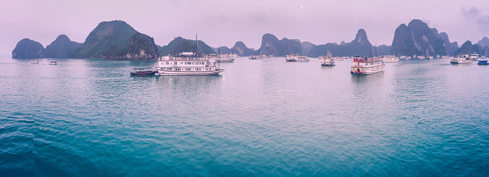 Aerial view of sunset and dawn near rock island, Halong Bay, Vietnam, Southeast Asia. UNESCO World Heritage Site. Junk boat cruise to Ha Long Bay. Popular landmark of Vietnam