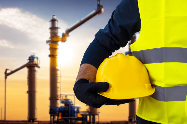 istock Construction worker engineer on the background of a gas plant under construction, a natural gas field, a gas pumping station. 1417915042