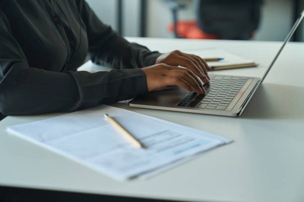 istock Woman sitting at the table and working on the computer 1417915491