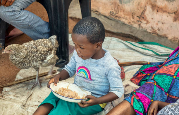 istock African child eating 1417915576