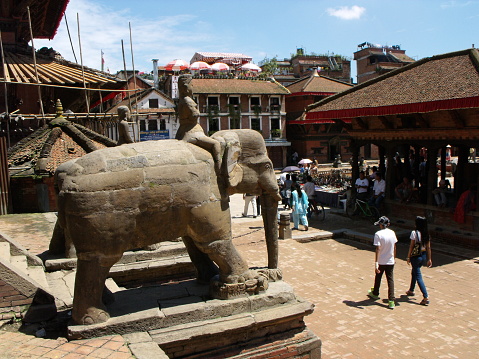 Durbar Square, Patan, Kathmandu, Nepal, August 20, 2011: Man on a stone elephant in Durbar Square, Patan, Kathmandu, Nepal