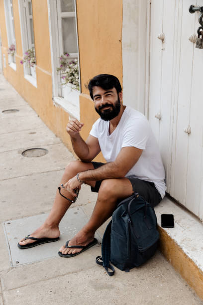 istock Man sitting on the sidewalk 1417916878