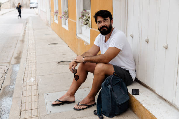 istock Man sitting on the sidewalk 1417916924