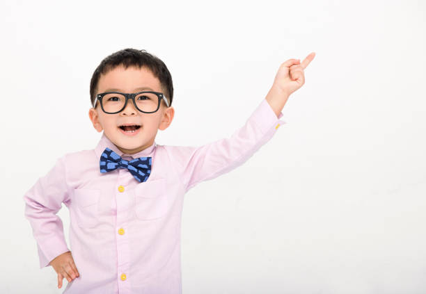 istock Happy Boy in a suit  and pointing to copy space 1417916974