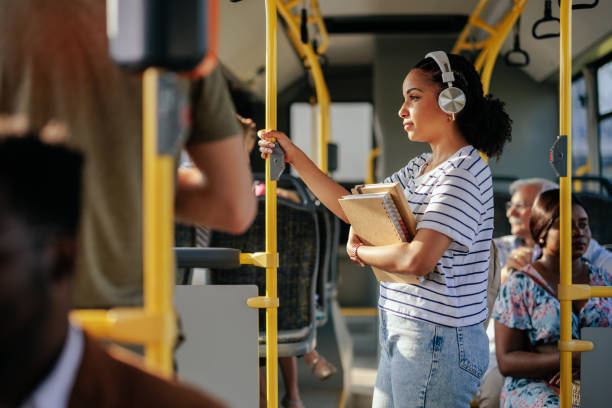 Student listening music in public bus stock photo