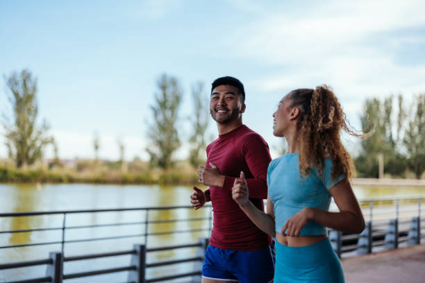 istock Sporty couple running at riverside 1417920194