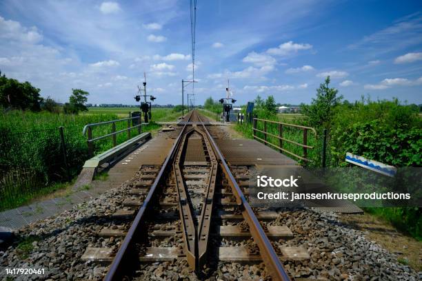 Railroad Crossing Between The Meadows In The Netherlands Stock Photo - Download Image Now