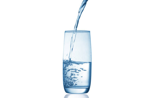 istock pouring water into glass isolated on white background 1417922123