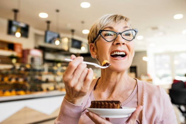 istock Senior women eating dessert 1417922325