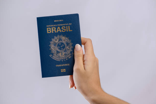 istock Brazilian passport in a hand with white background. 1417922718