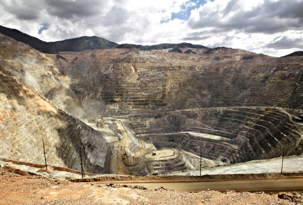istock Large quarry site. Big yellow mining truck at work site. Loading sand into body truck. Production useful minerals. Mining truck mining machinery to transport coal from open-pit production 1417923046