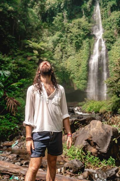 vertical shot of a caucasian male posing for a photo in bali, indonesia - bali male beautiful ethnicity imagens e fotografias de stock