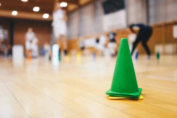 Photo of Sports Basketball Training Session For Youth Talented Players. Basketball Training Cones at Sports Hall