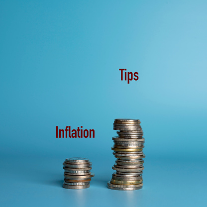 two stacks of coins side by side show the difference in tip growth versus inflation