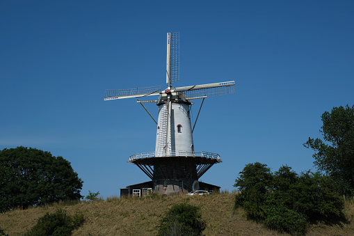 Close up of tower mill the 'de Koe' in Veere, Zeeland, the Netherlands. Vertical windmill consisting of a brick or stone tower.