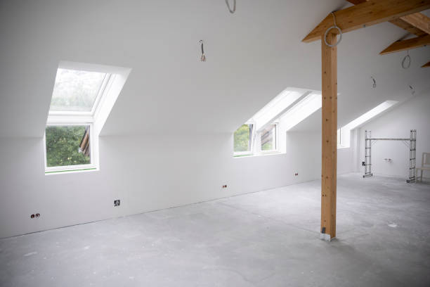 istock attic construction site freshly painted, the floor is still screed, walls are white 1417928778