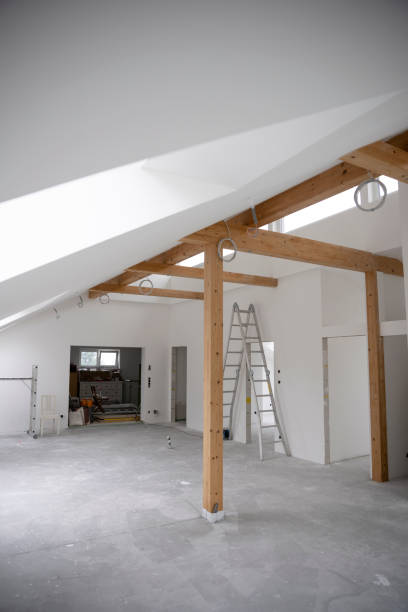 istock attic construction site freshly painted, the floor is still screed, walls are white 1417929859