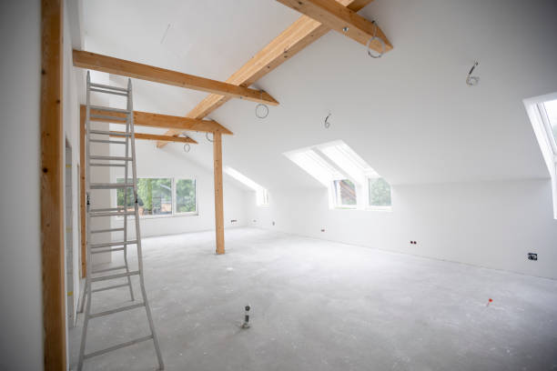 istock attic construction site freshly painted, the floor is still screed, walls are white 1417930608