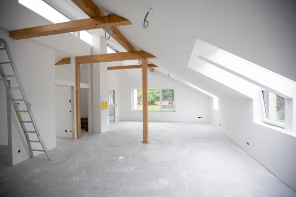 istock attic construction site freshly painted, the floor is still screed, walls are white 1417932389
