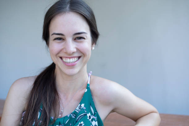 istock young smiley woman looking at camera 1417933128