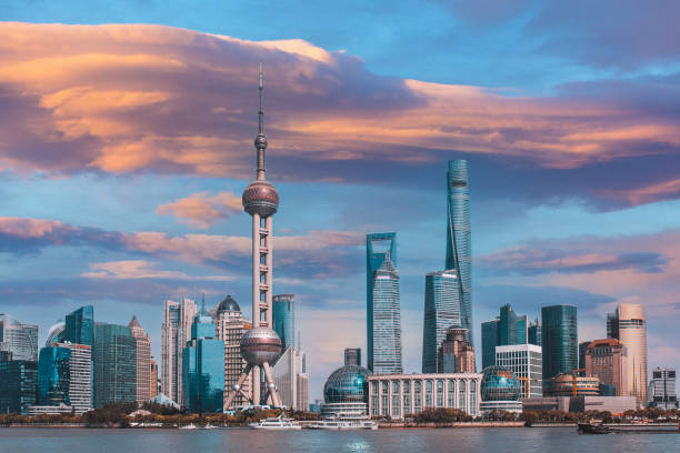 sunset Shanghai skyline and Shanghai tower at dawn China, Shanghai skyline at dawn, showing the Huangpu river with passing cargo ships and Pudong skyline. shanghai world financial center stock pictures, royalty-free photos & images