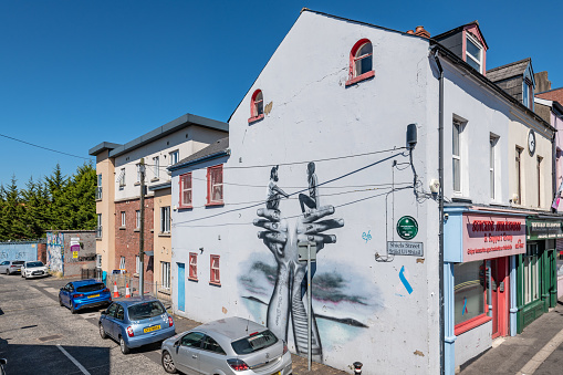 Ljubljana, Slovenia - August 21, 2020: A panorama picture of a building with street art on display at the Metelkova Art Center. The artist's name is Raze.