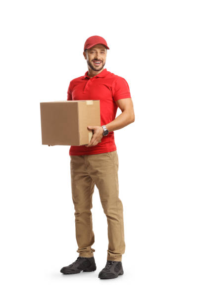 Smiling courier holding a cardboard box stock photo